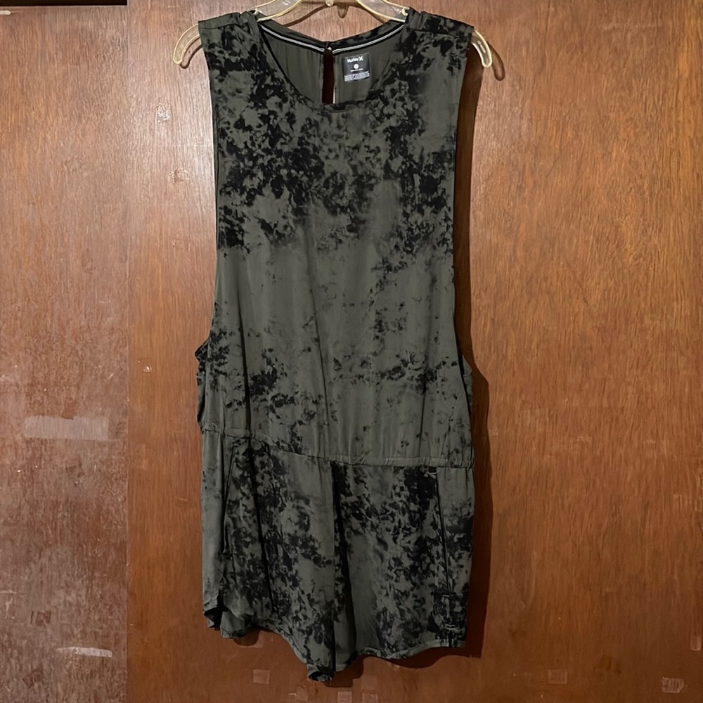 Summer romper with pocket.  Loose fit with peek a boo back.  Never worn.